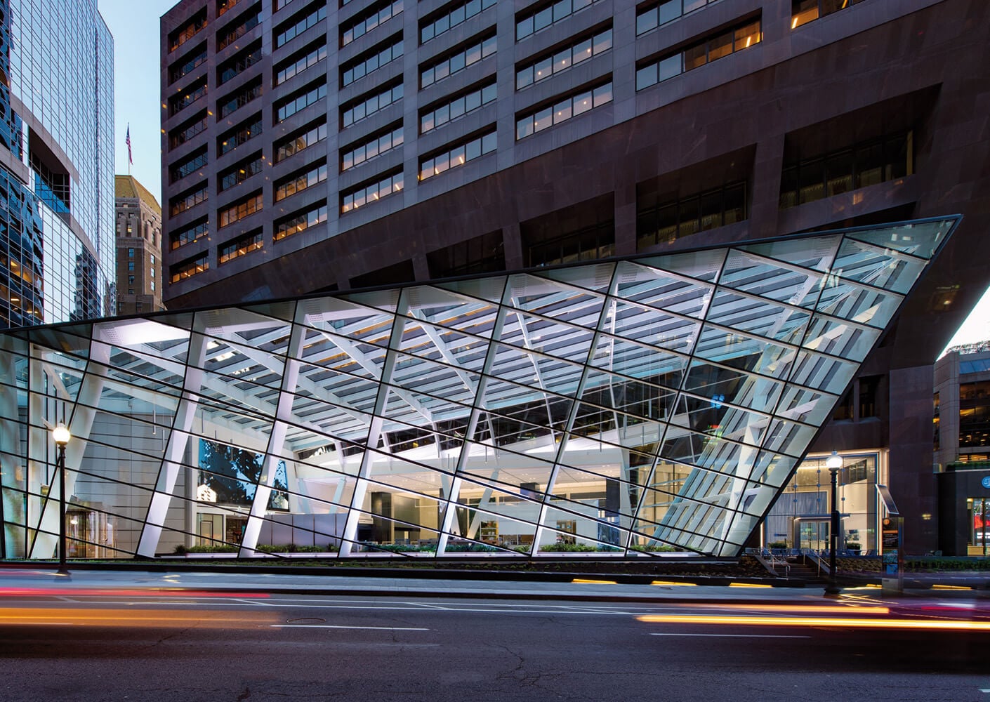 Modern glass architectural design of urban building at twilight.