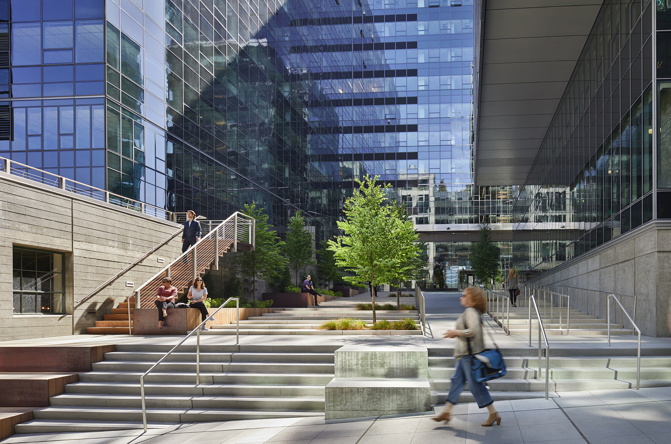 Ground view of Troy Block's outdoor cross-block connection with people sitting on raised planters
