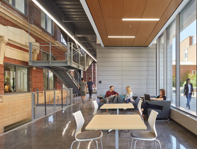 Interior atrium with students conversing and studying