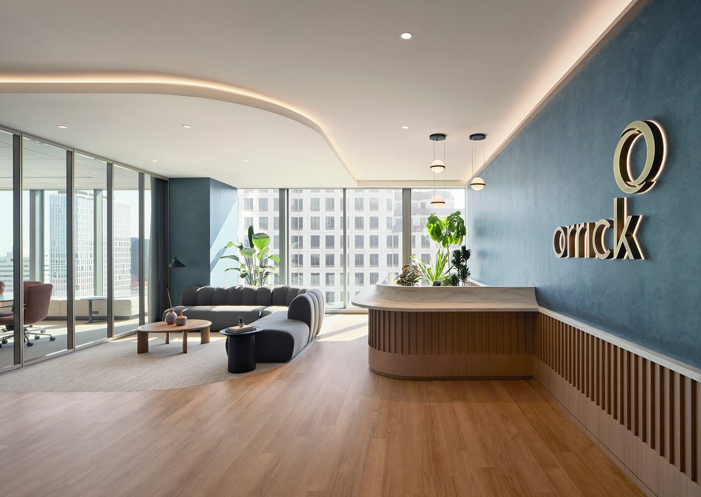 Modern law office lobby with stylish seating, wooden floors, and a large window view, featuring plants and contemporary lighting.