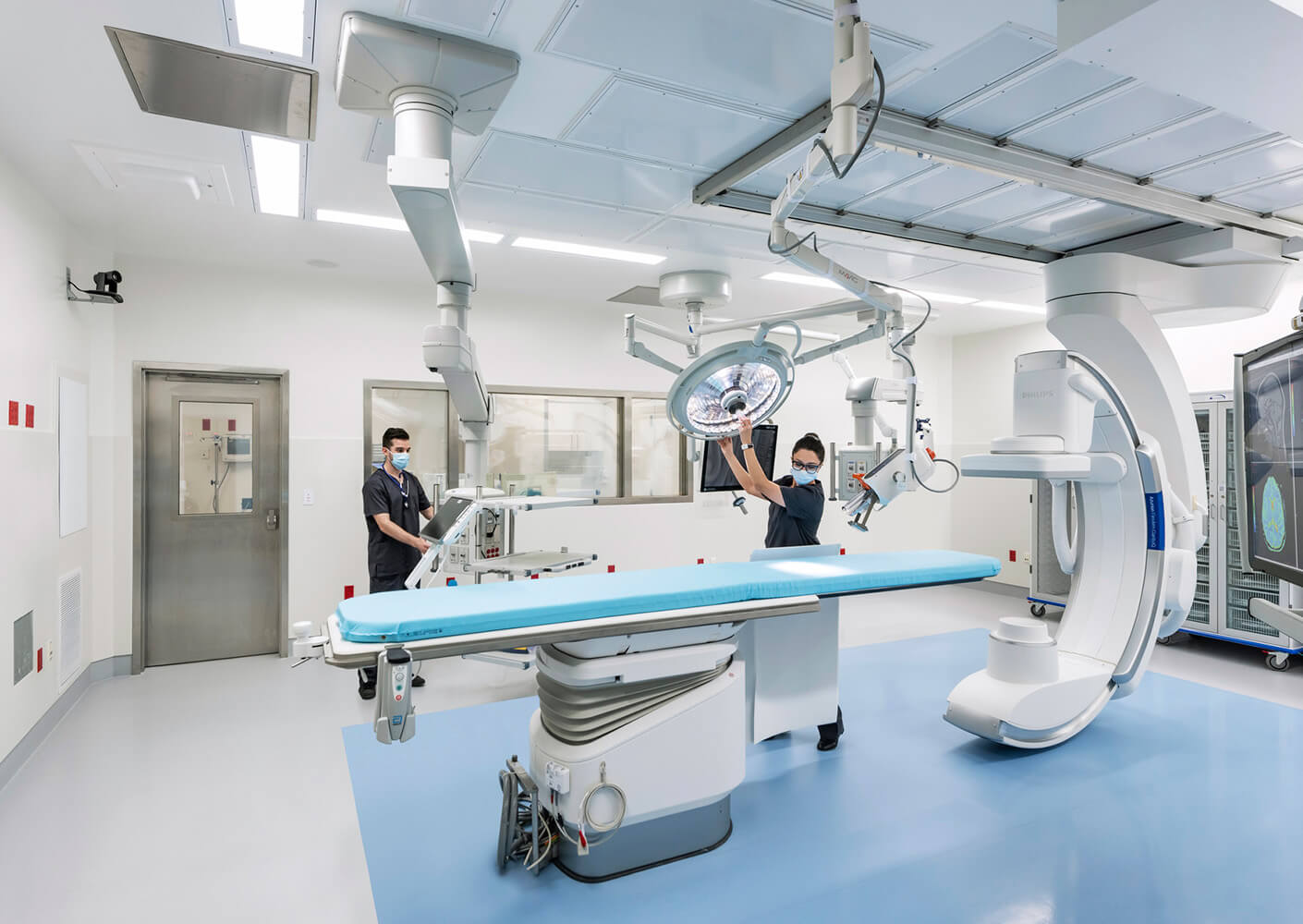 Operating room with people setting up equipment