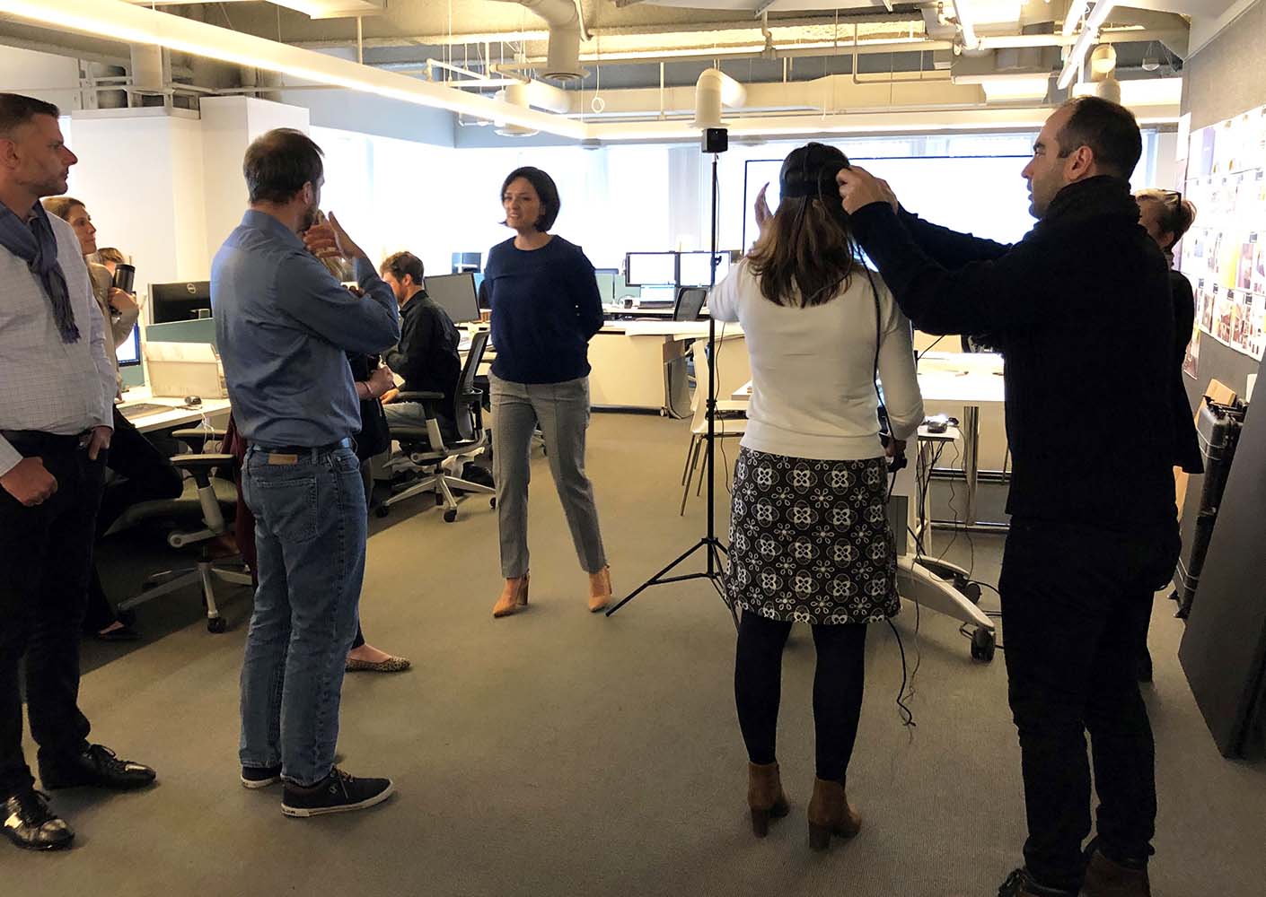 Laura leads a group through a virtual reality tour of the space