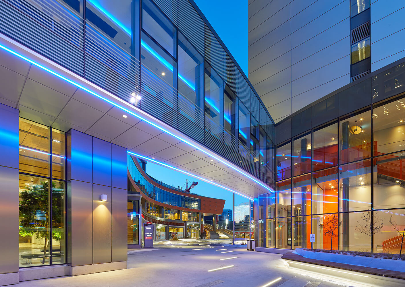 A view of True North Square showing the pedestrian skybridge in the foreground.