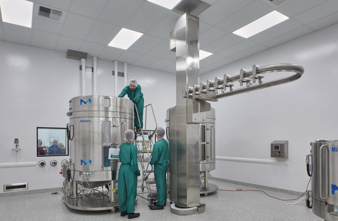 cGMP lab with people working in full PPE