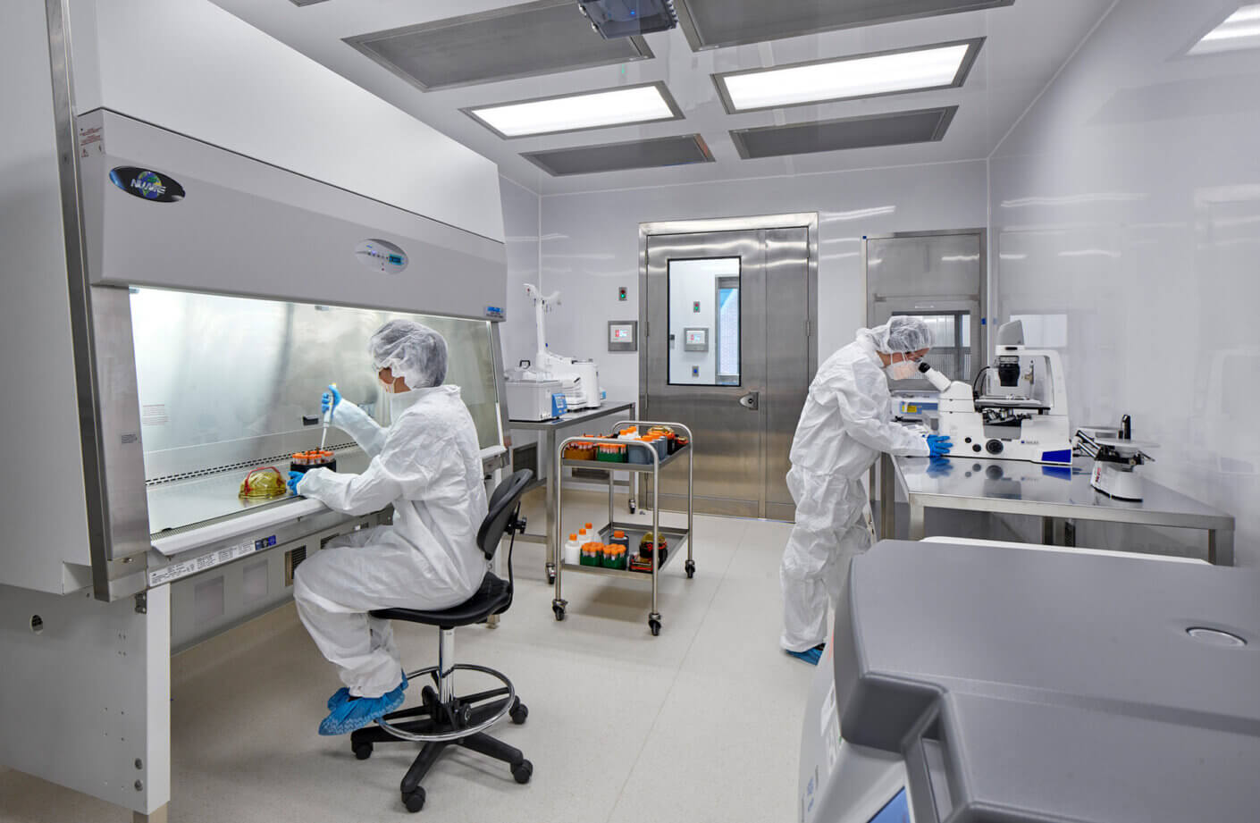 cGMP lab with people working in full PPE