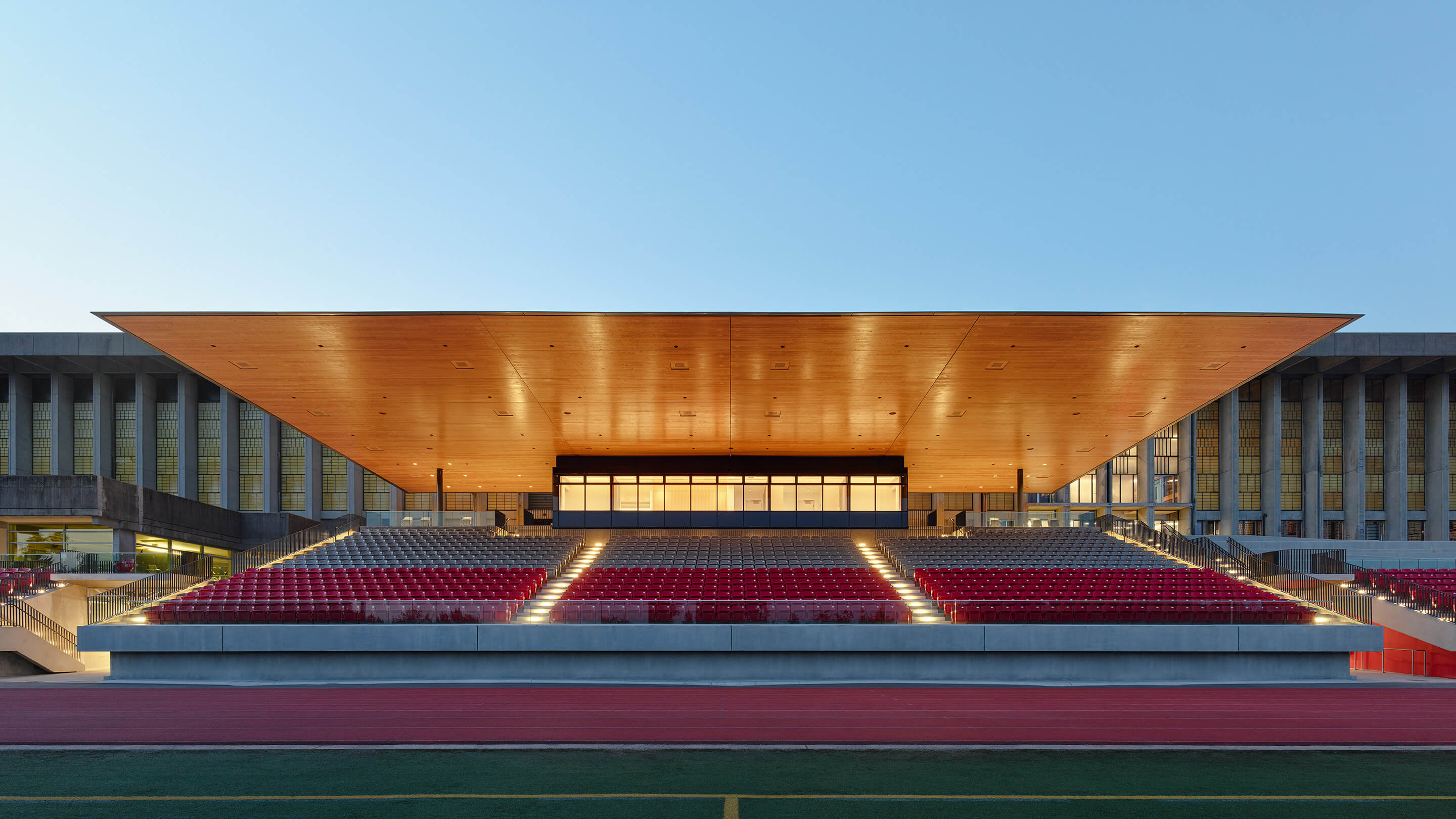 Photo showing innovative stadium canopy illuminated at dusk