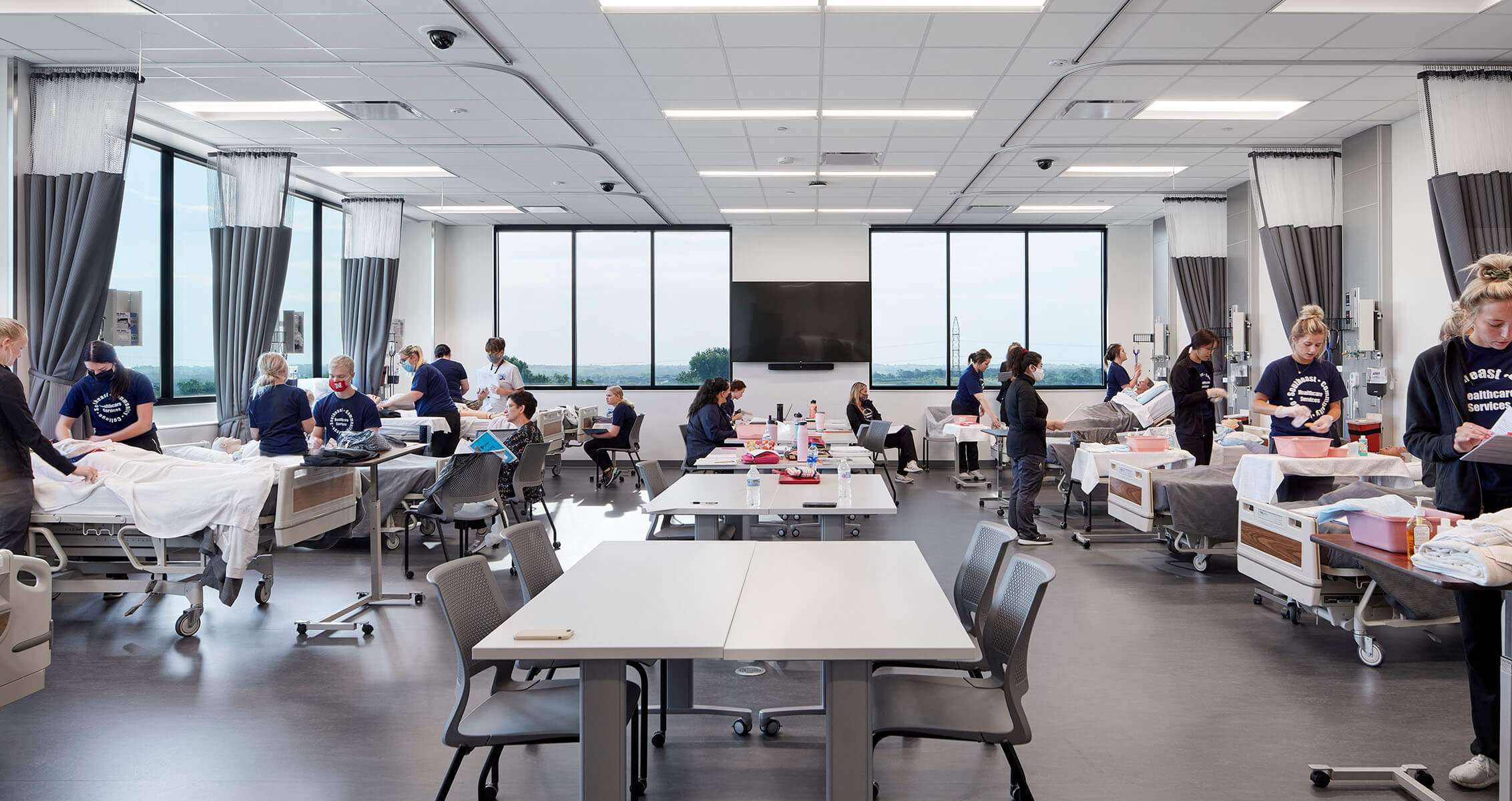Photo of students in a nursing simulation room.