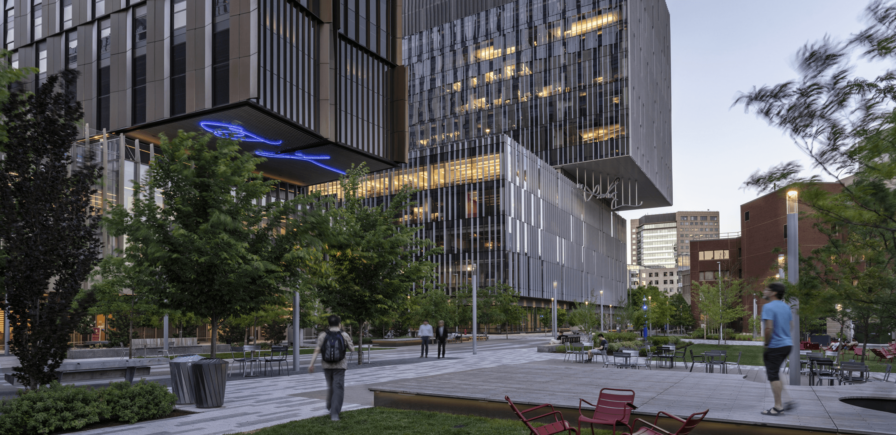 Photo of multi-story research laboratory building in Kendall Square showing active community greenspace.
