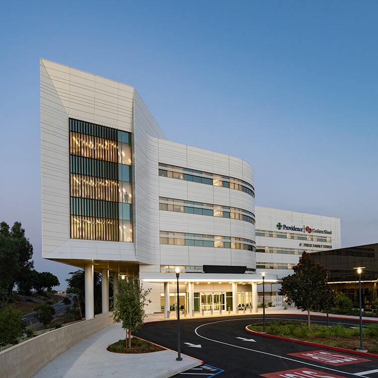 Modern hospital building exterior with glass windows and sleek design.