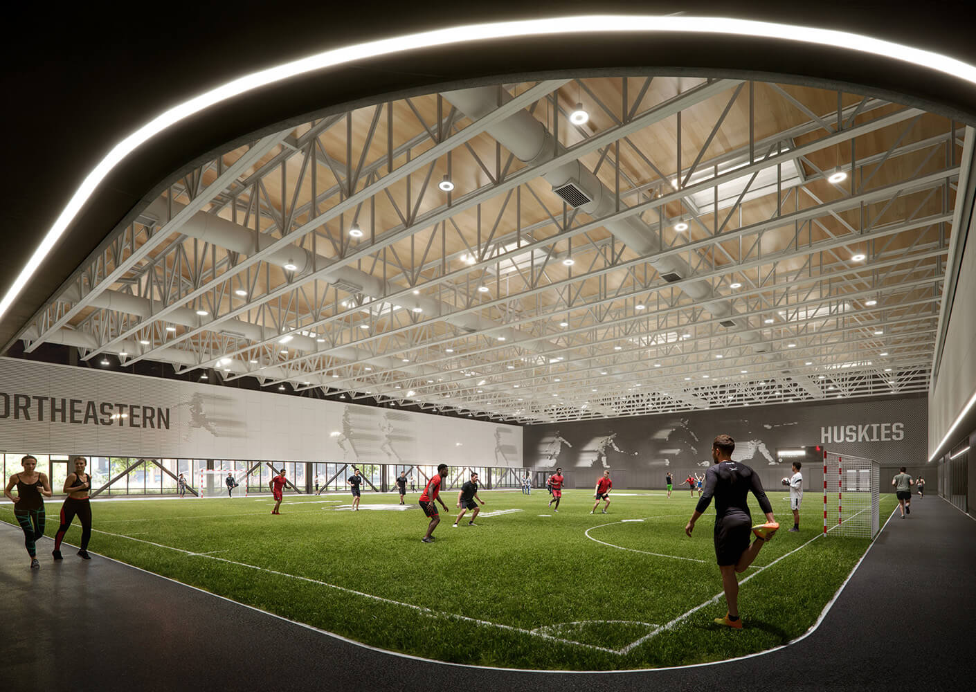 Indoor sports facility at Northeastern University with athletes training on artificial turf. Features a metal and wood ceiling design.