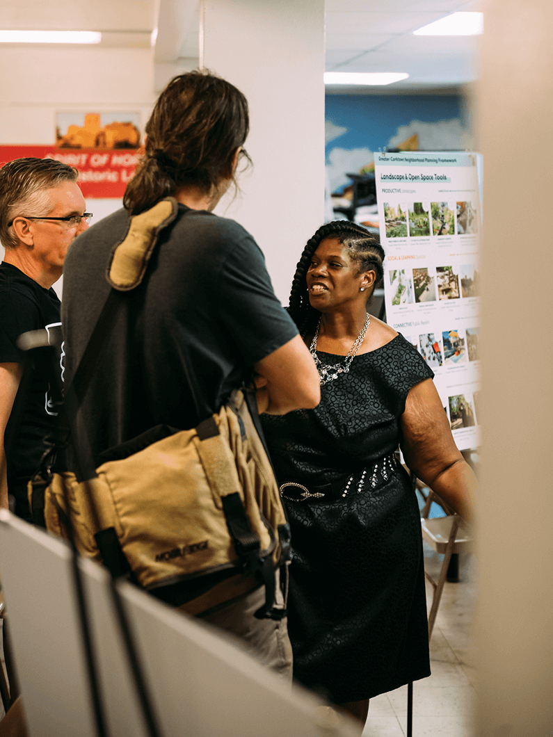 3 people talking at community meeting