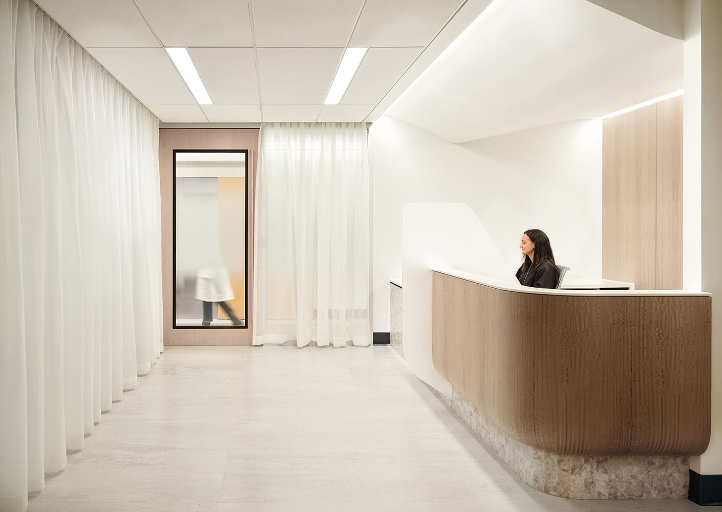 Bright, modern reception area with light curtains and diffused lighting