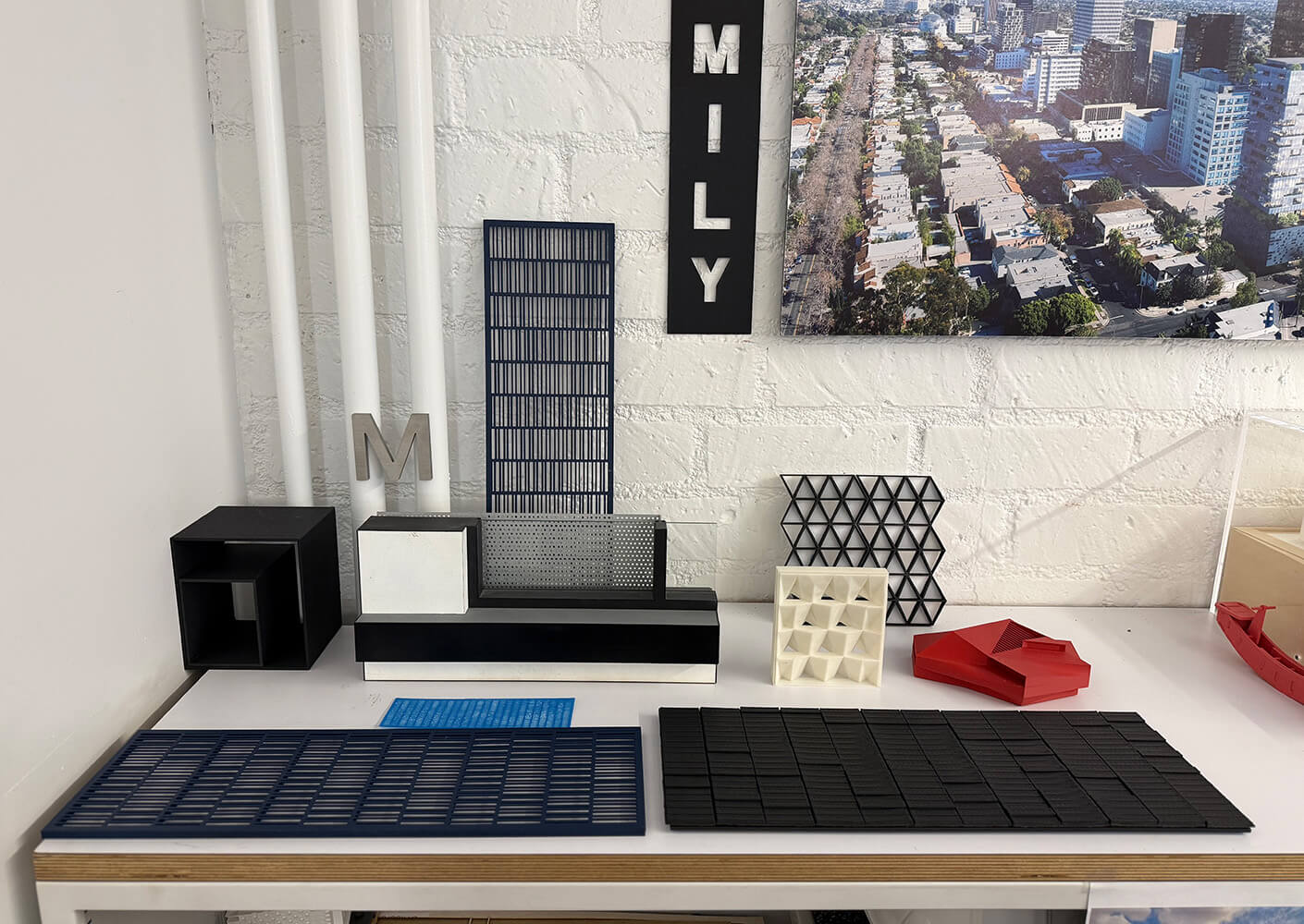 Architectural models and materials displayed on a table.