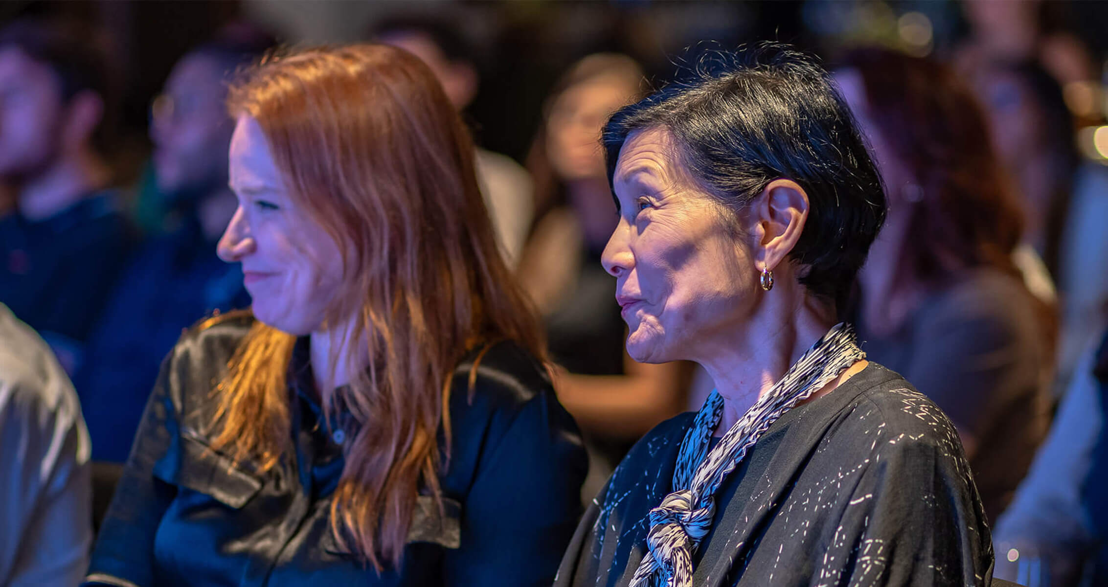 Audience engaged in a lively discussion at a conference event.