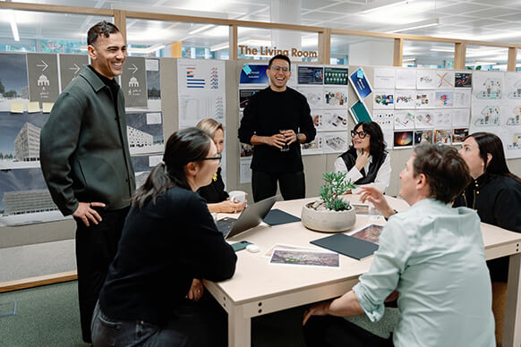 Team brainstorming session in modern office with presentation boards.