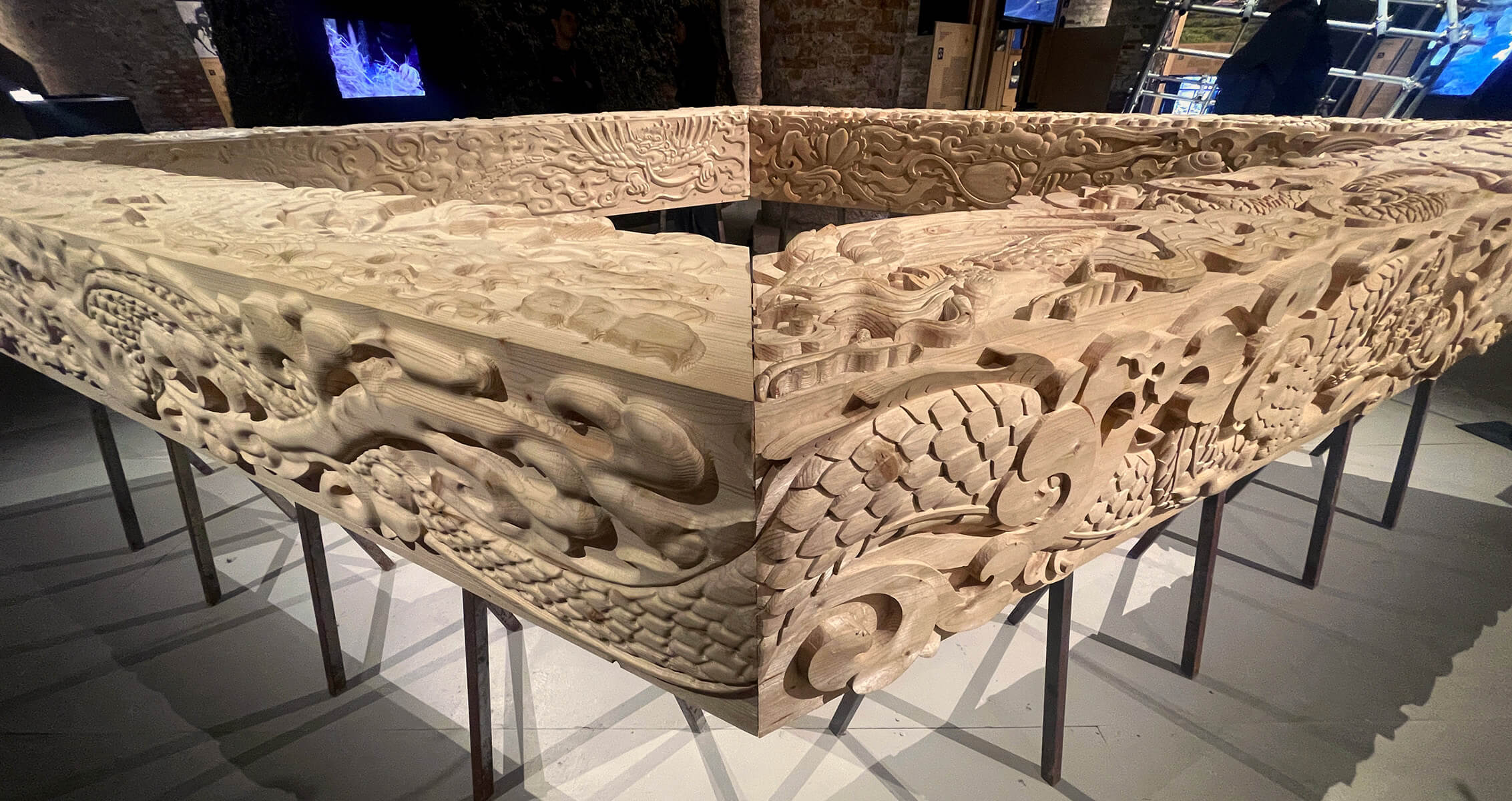 Intricately carved wooden structure with detailed patterns on display.