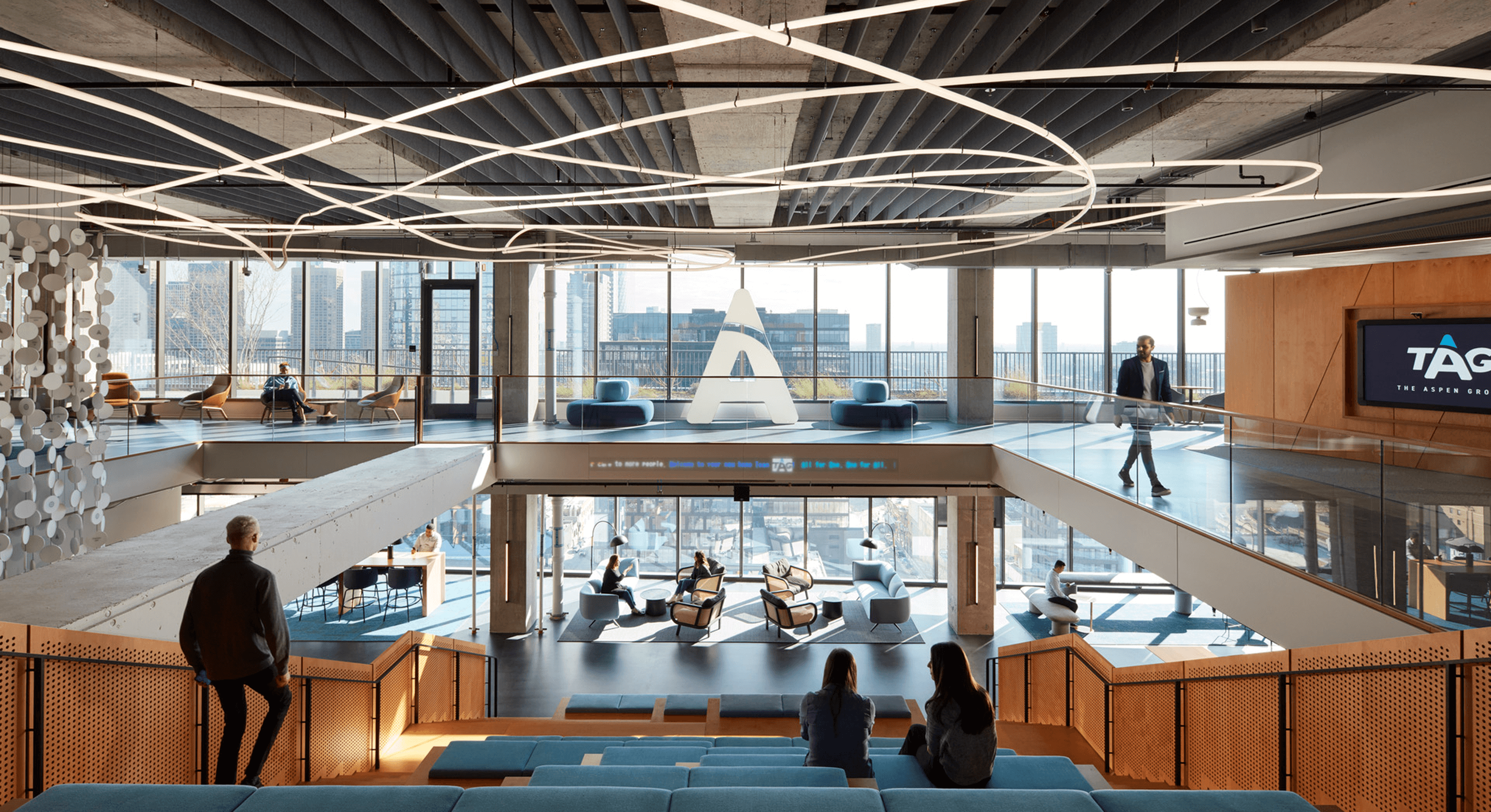 Modern office interior with open spaces and panoramic city views.