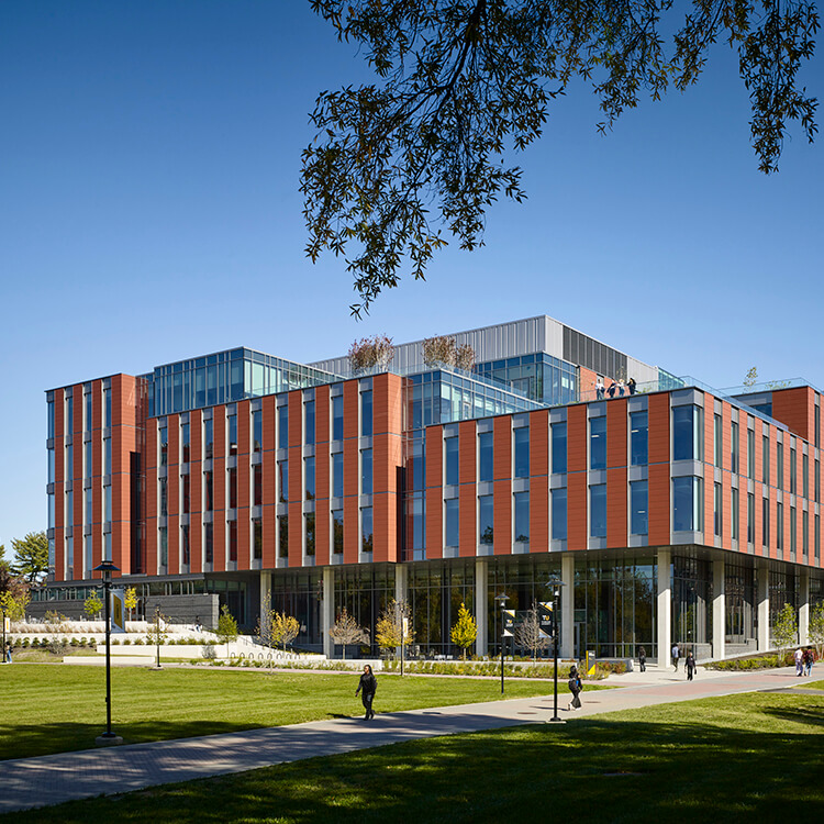 Modern building with glass and brick facade on a clear day.