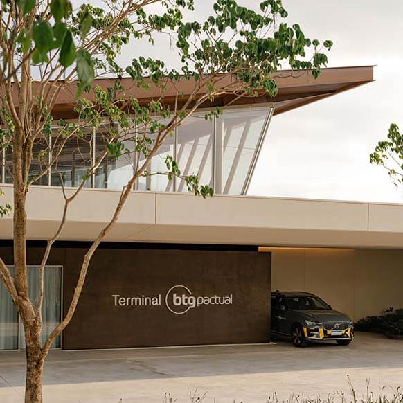 Modern building with Terminal BTG Pactual sign and a car parked nearby.