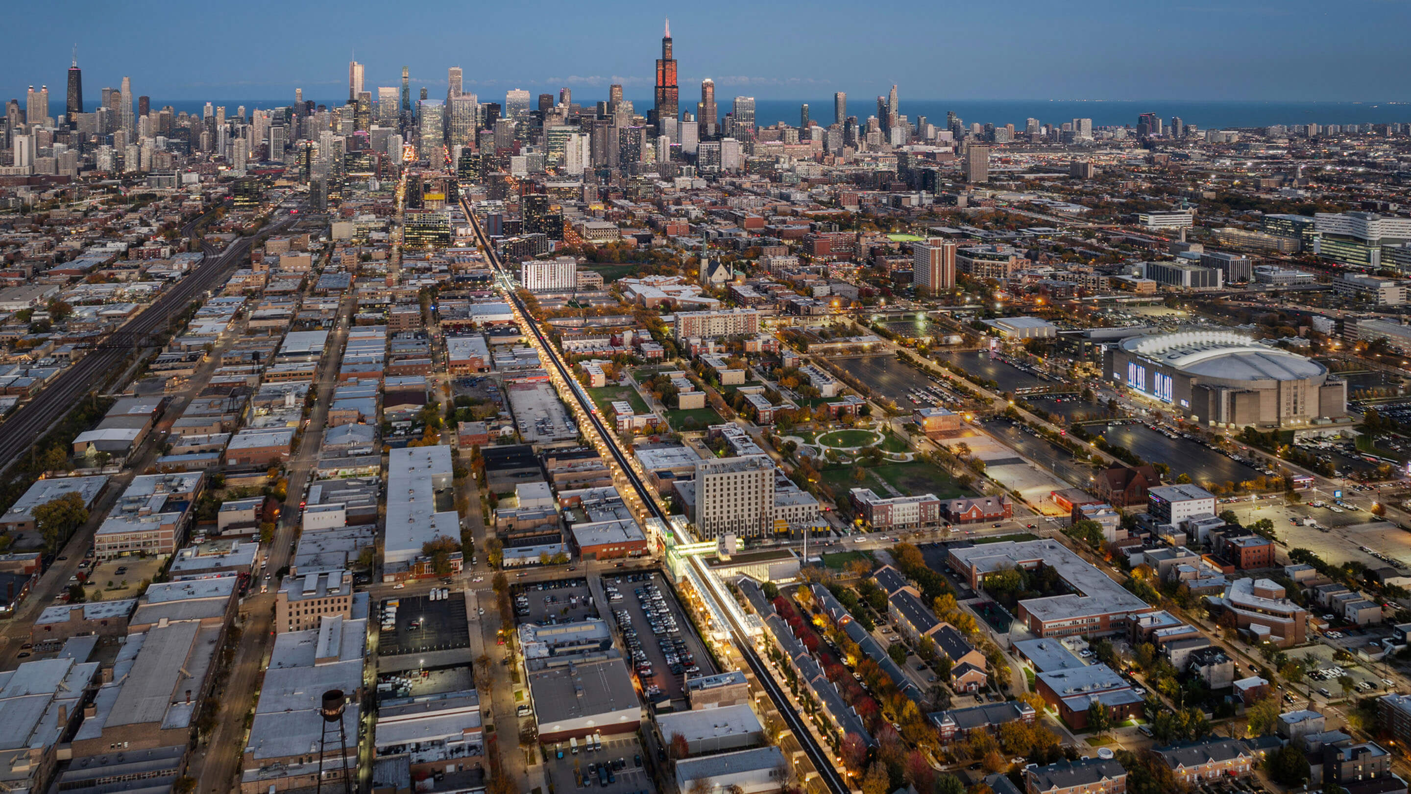 Aerial view of downtown skyline at sunset with urban cityscape and skyscrapers.