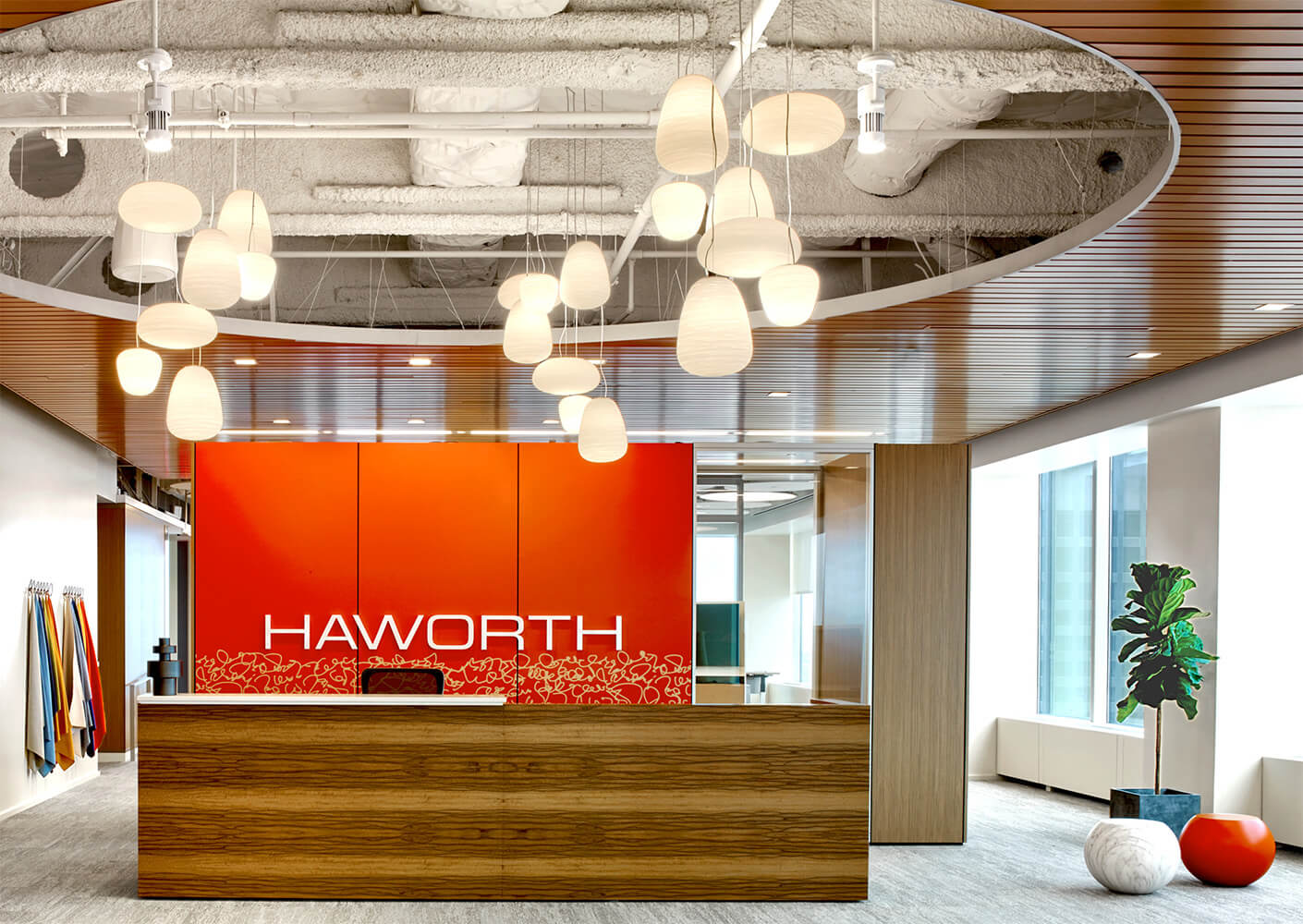 Modern reception area with orange accents and stylish lighting fixtures.