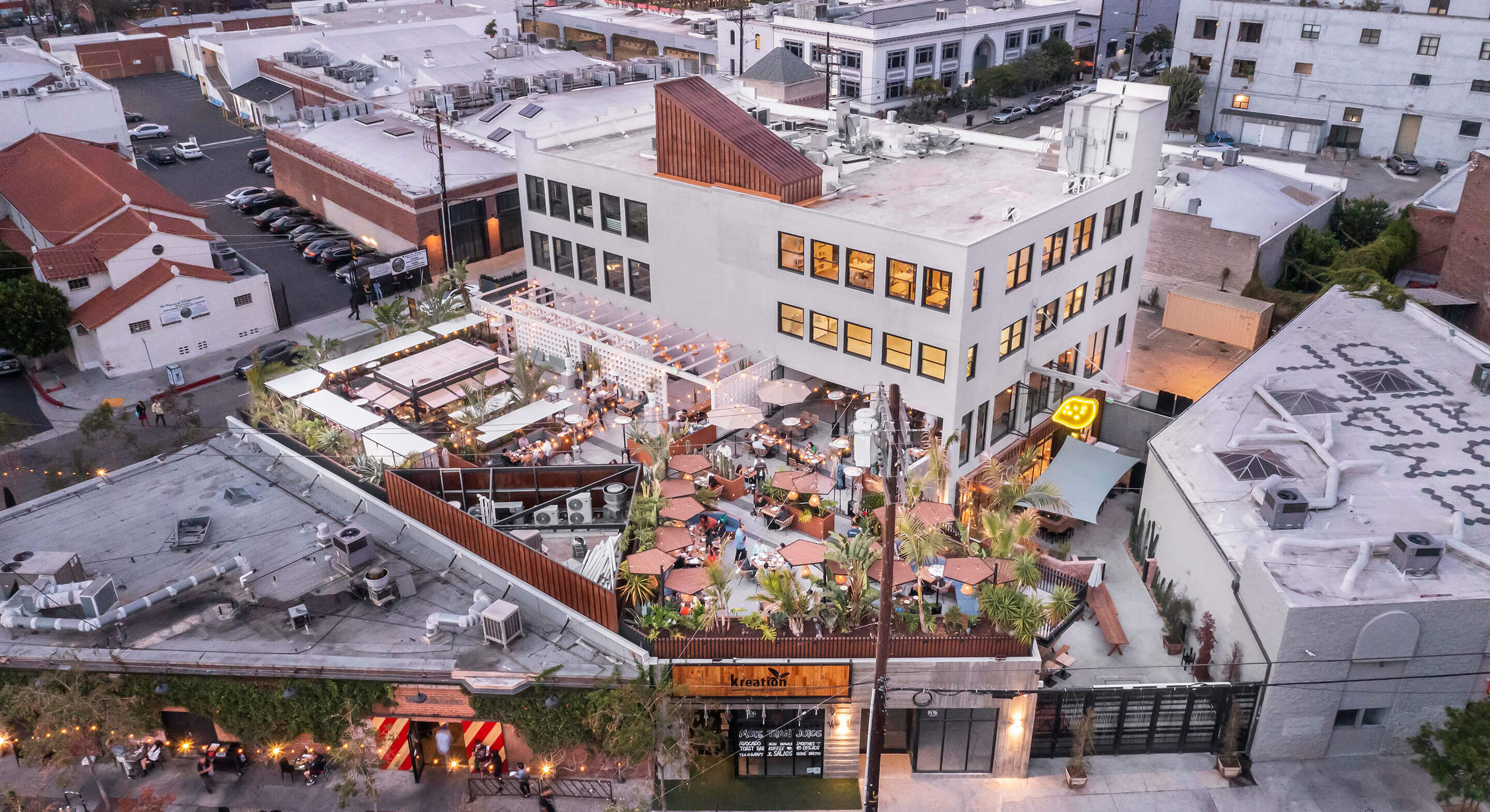 Aerial view of a bustling rooftop restaurant with outdoor seating.