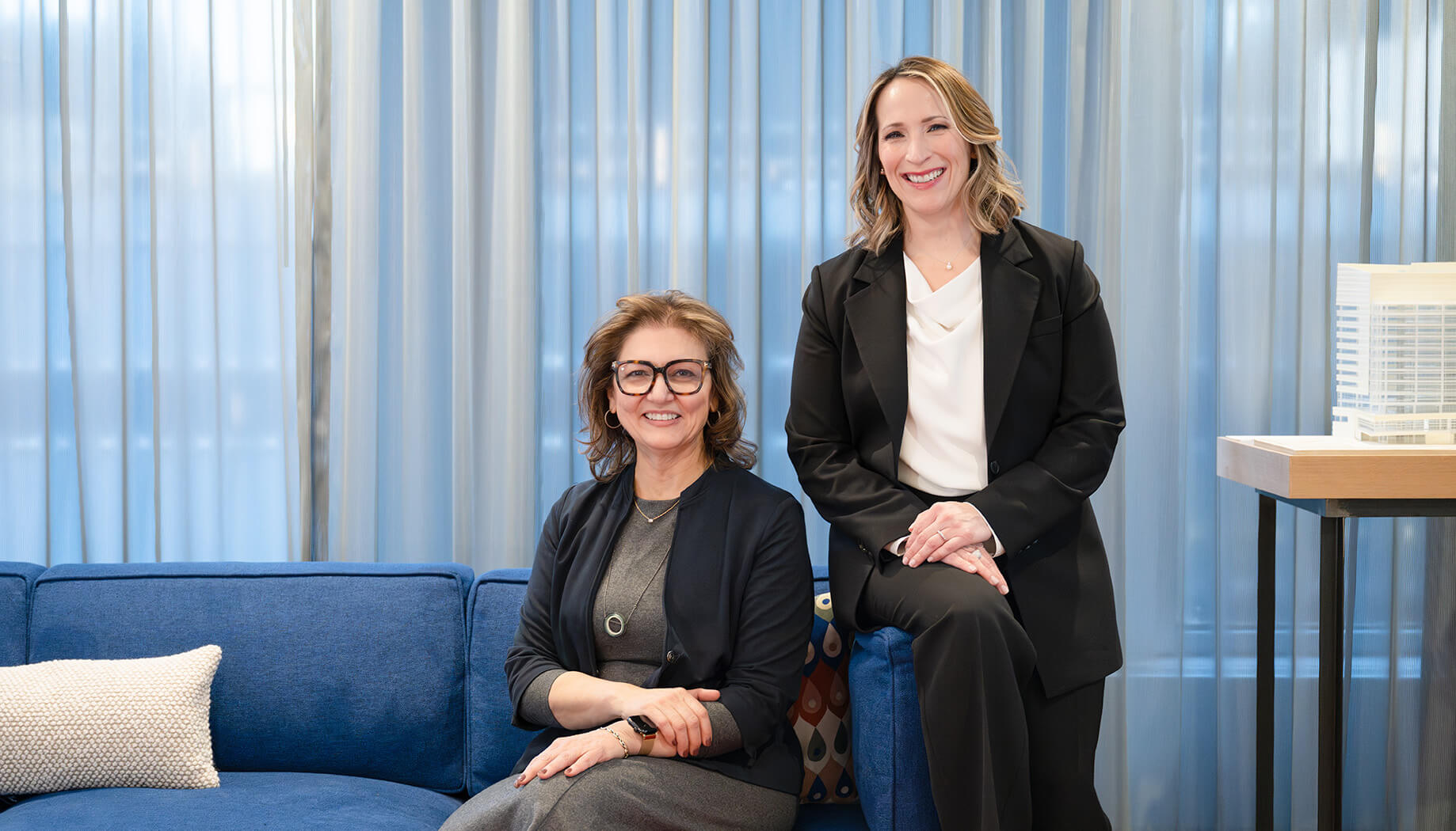 Yanel and Vickie smiling in an office setting