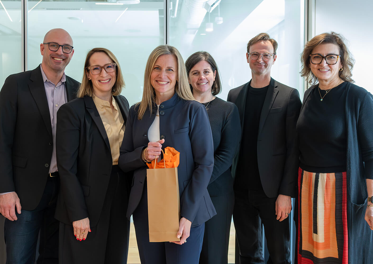 Abby Gillespie and Boston studio leadership posing together in an office setting.