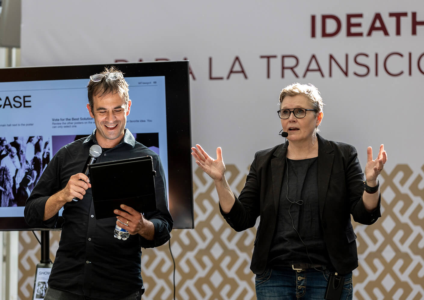 Gilad and a presenter engage an audience on stage