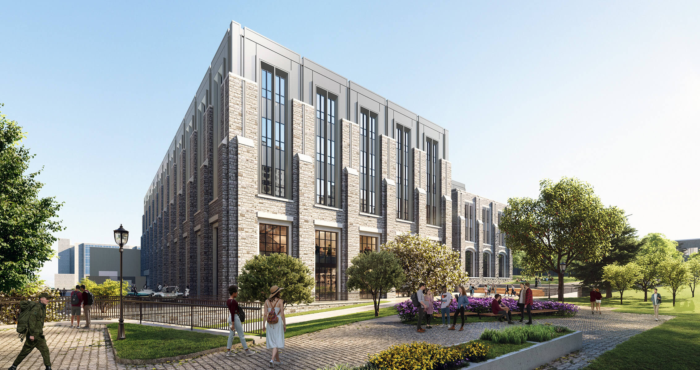 New stone building with large windows, surrounded by greenery and people walking in a landscaped area. Clear blue sky above.