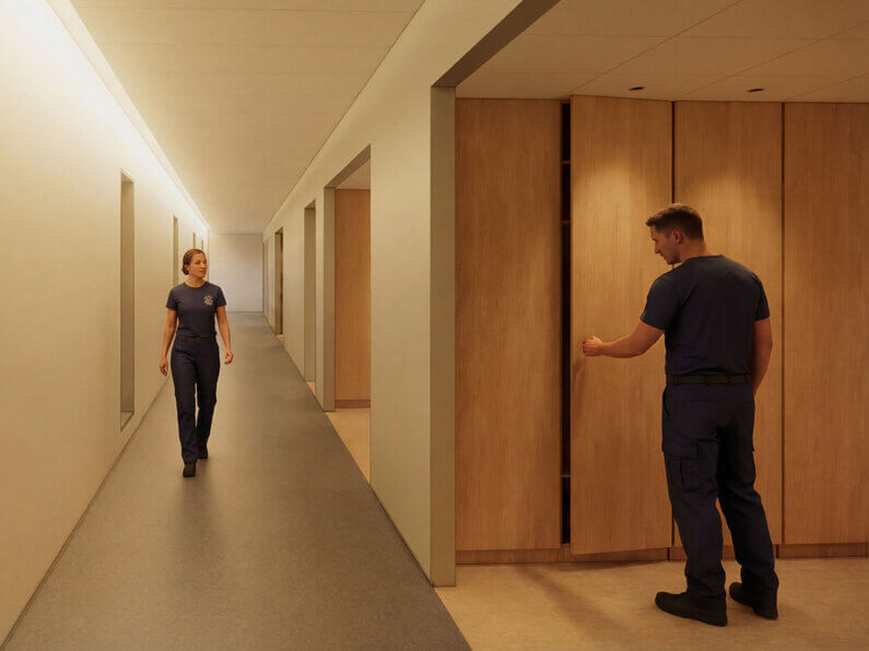 Two uniformed individuals in a hallway interact with storage lockers and walkways in a facility, featuring wooden finishes and minimal decor.