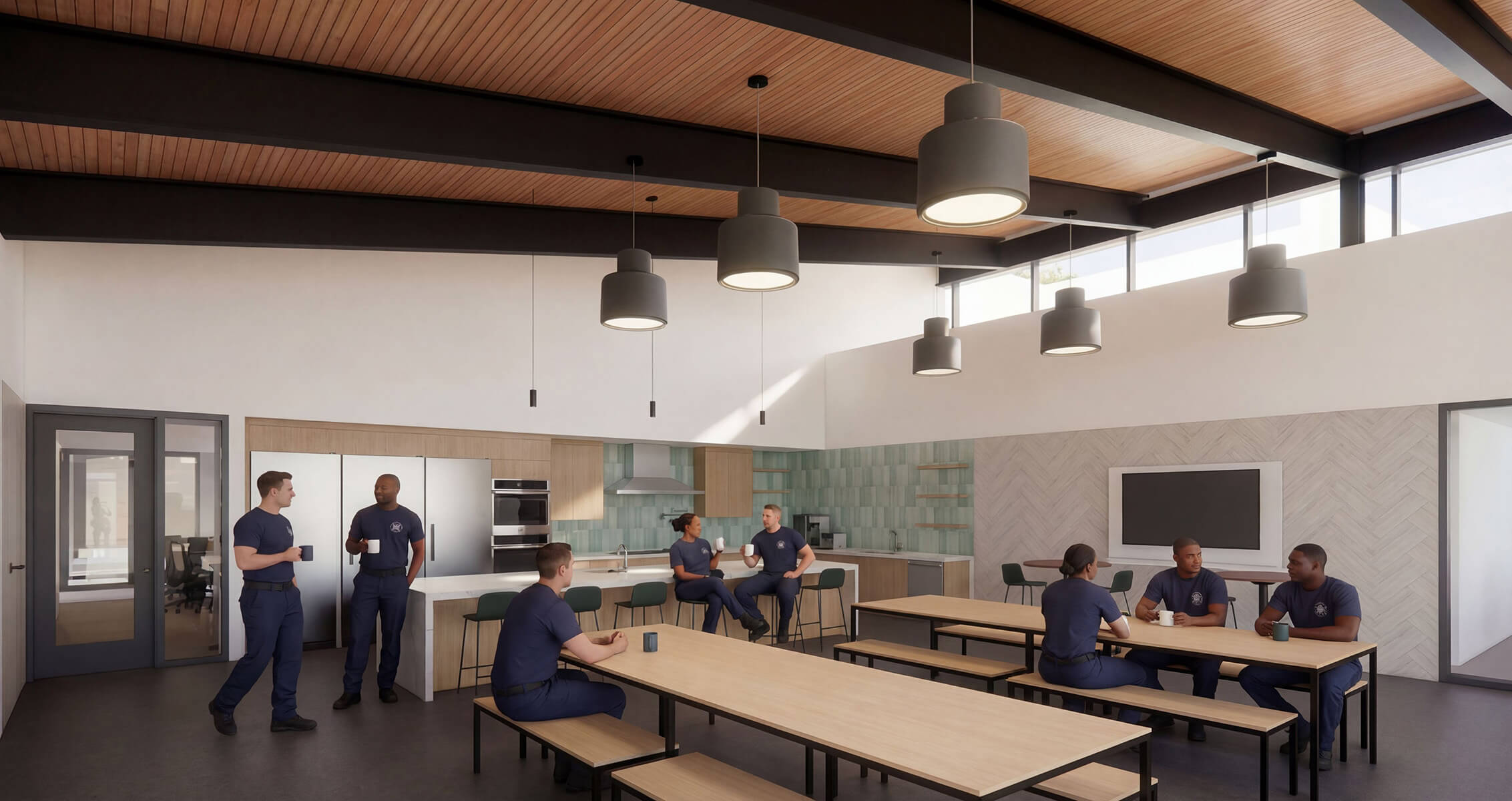 Firefighters gather in a communal kitchen area, conversing and enjoying coffee in a functional space with wooden beams and modern appliances.