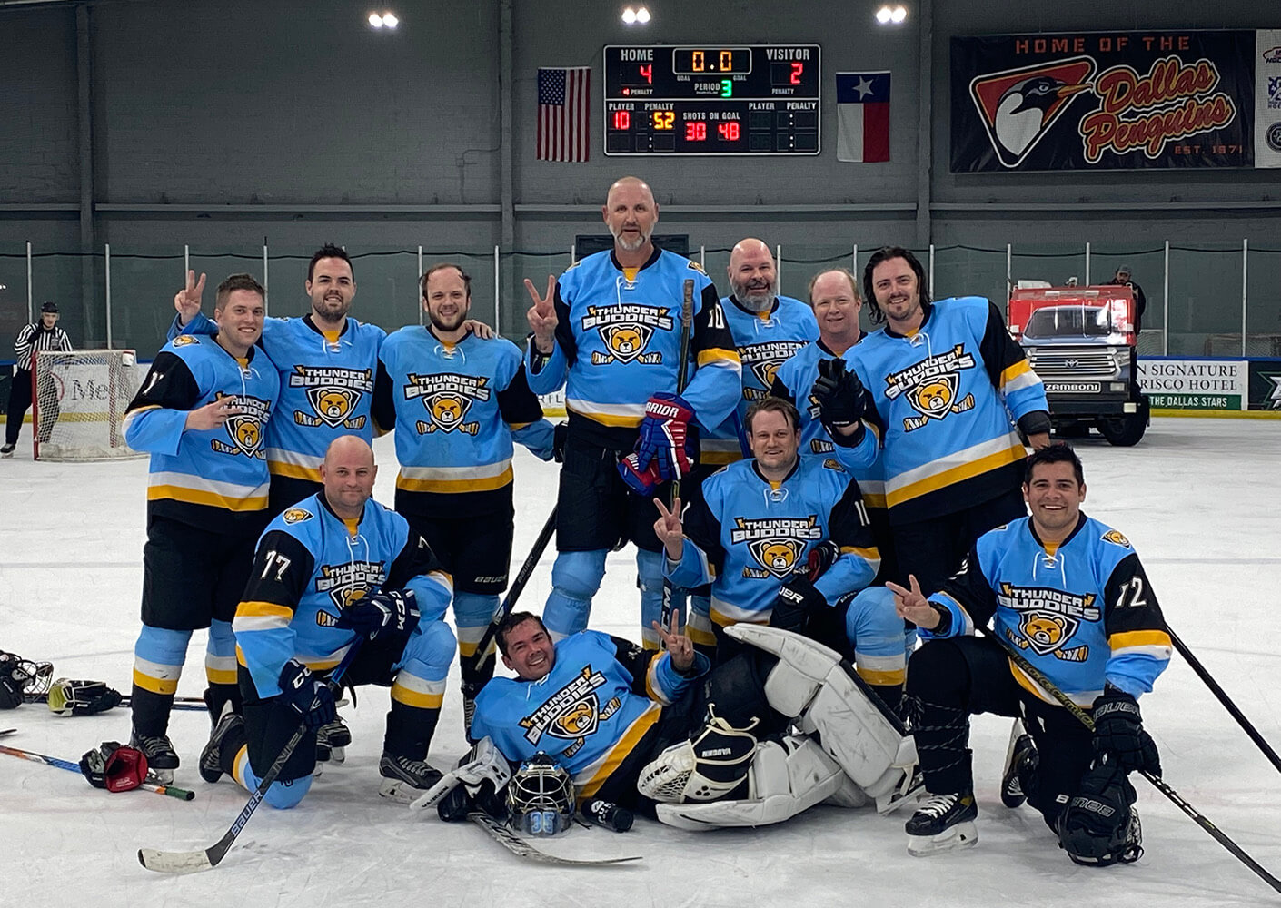 Ben poses with his Thunder Buddies hockey team on the ice
