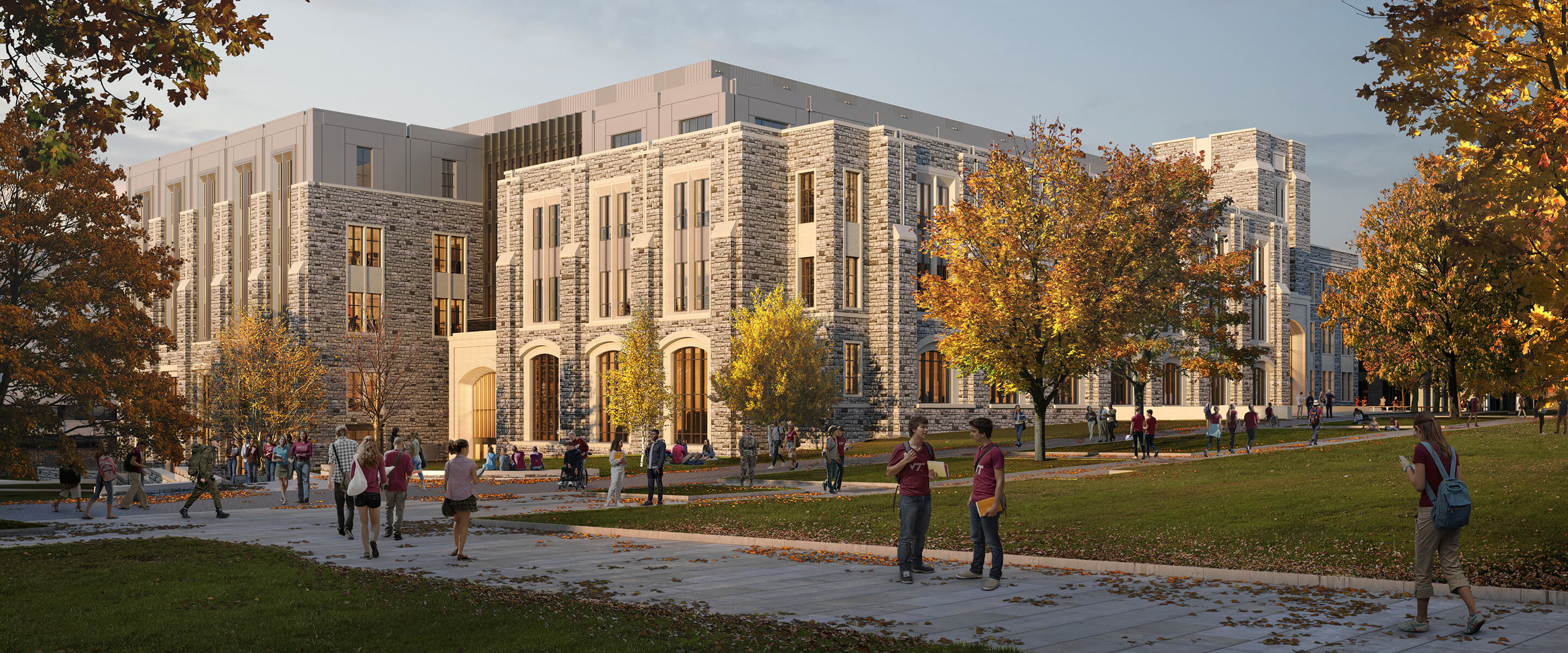 Students gather on a university campus featuring stone architecture and landscaped pathways, surrounded by trees in autumn foliage.