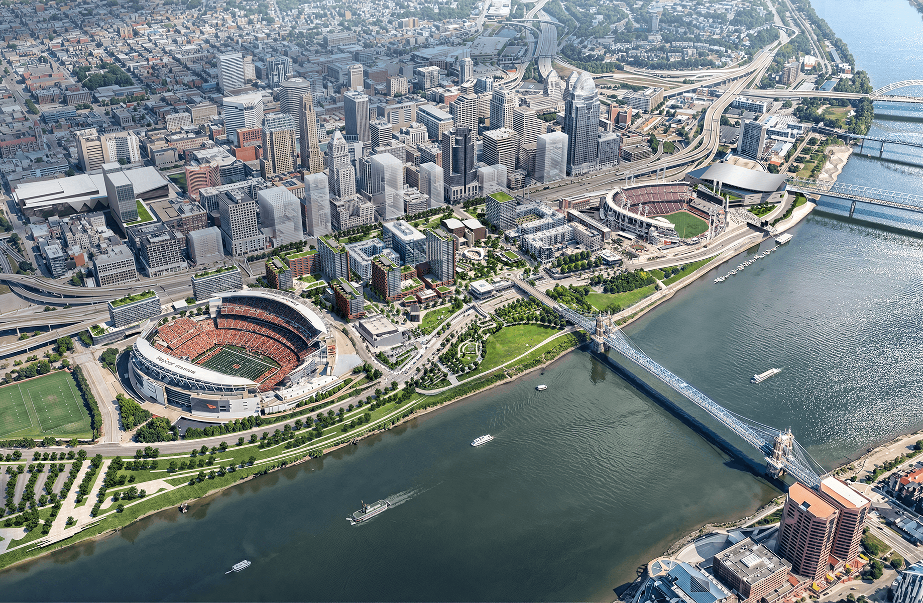 Aerial view of a downtown city with sports stadiums, parks, and a riverfront. Features urban buildings and bridges in a vibrant landscape.