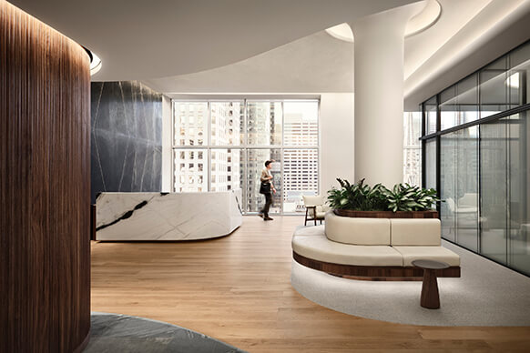Interior view of a corporate office lobby featuring a reception area, seating, large windows, and greenery elements.