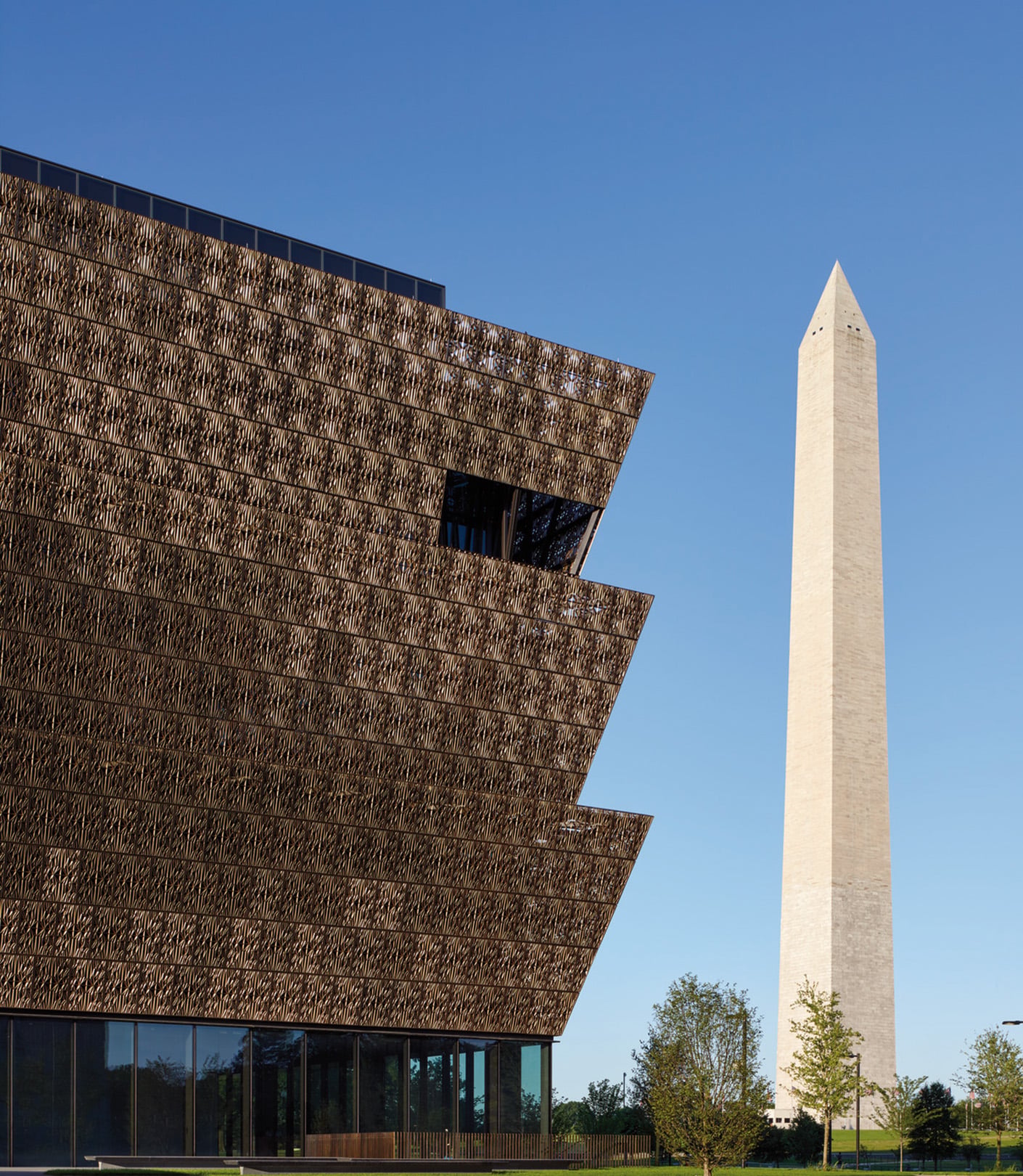 Smithsonian National Museum of African American History and Culture exterior, featuring unique architectural design and the Washington Monument in the background.